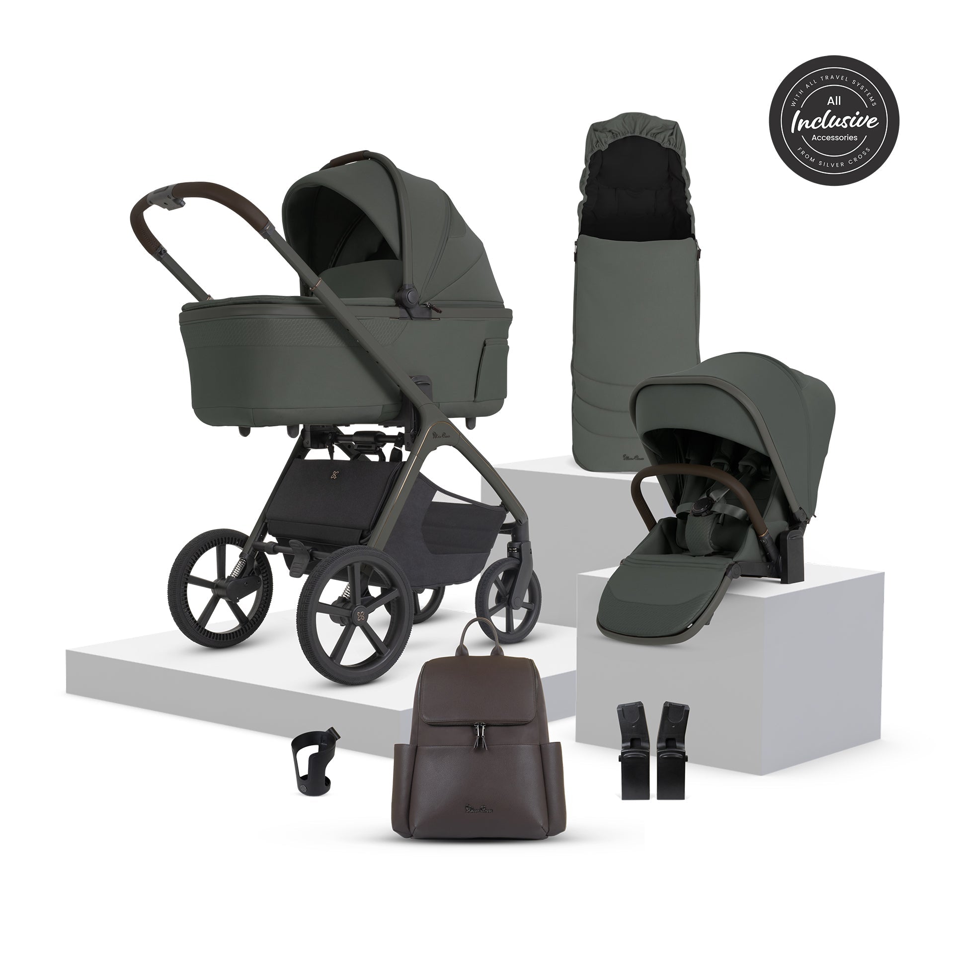 Complete travel system with green pushchair, car seat, carrycot, changing bag, and accessories displayed on white platform